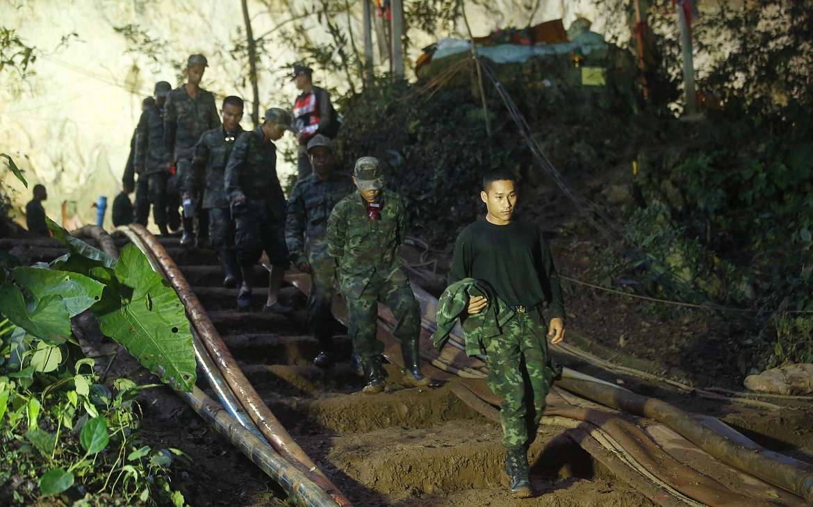 Rescuers make their way down at the entrance to a cave complex where 12 boys and their soccer coach went missing, in Mae Sai, Chiang Rai province, in northern Thailand, Monday, July 2, 2018. Rescue divers are advancing in the main passageway inside the flooded cave in northern Thailand where the boys and their coach have been missing more than a week. (AP Photo/Sakchai Lalit)