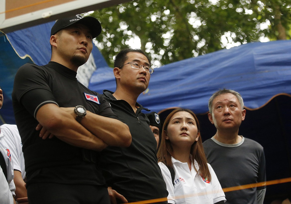 China's rescue team members join in a meeting with U.S. Special Operations Command Pacific Search and Rescue team personnel as they conduct search operation for missing 12 boys and their soccer coach, in Mae Sai, Chiang Rai province, in northern Thailand, Monday, July 2, 2018. Rescue divers are advancing in the main passageway inside the flooded cave in northern Thailand where the boys and their coach have been missing more than a week. (AP Photo/Sakchai Lalit)