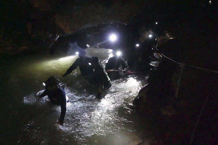 In this handout photo released by Tham Luang Rescue Operation Center, Thai rescue teams walk inside cave complex where 12 boys and their soccer coach went missing, in Mae Sai, Chiang Rai province, in northern Thailand, Monday, July 2, 2018. Rescue divers are advancing in the main passageway inside the flooded cave in northern Thailand where the boys and their coach have been missing more than a week. (Tham Luang Rescue Operation Center via AP)