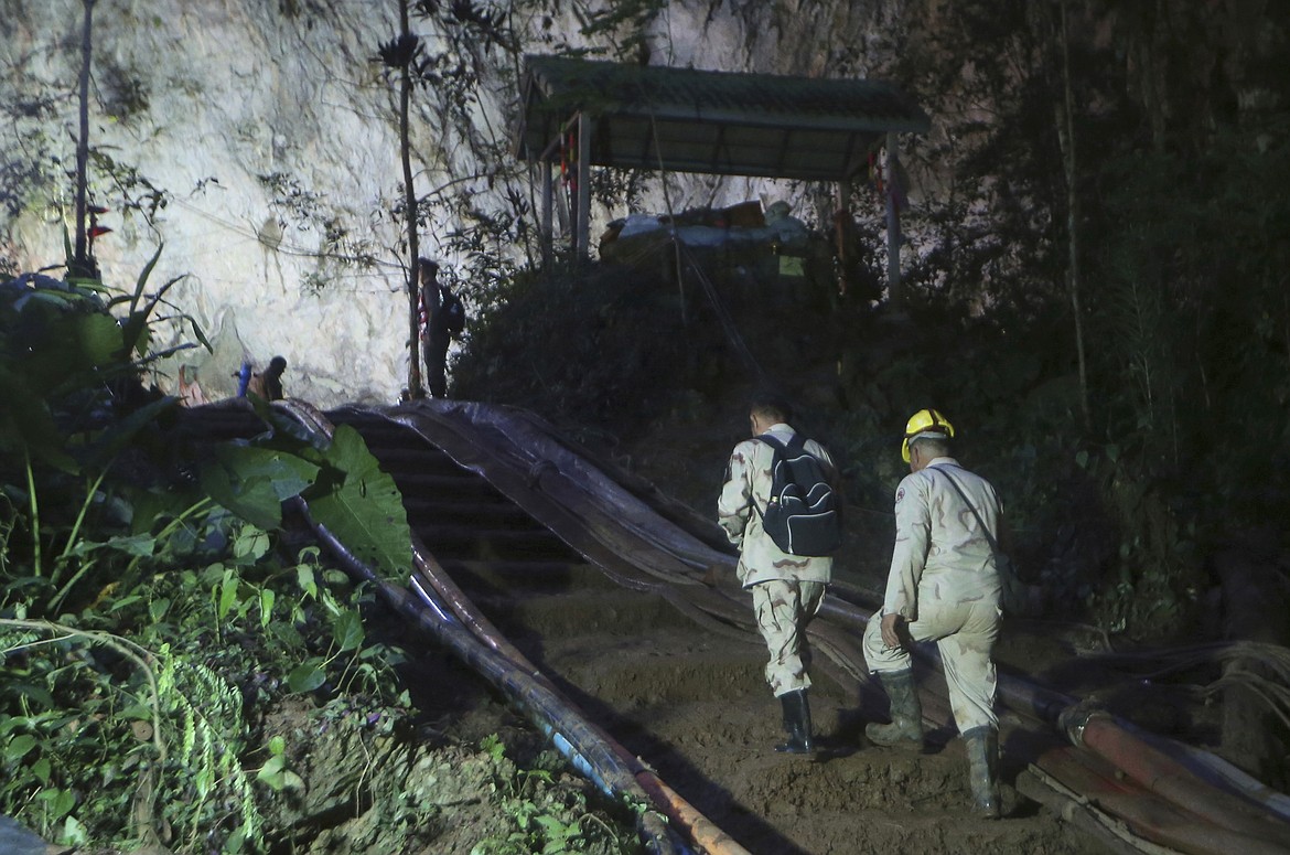 Rescuers make their way up at the entrance to a cave complex where 12 boys and their soccer coach went missing, in Mae Sai, Chiang Rai province, in northern Thailand, Monday, July 2, 2018. Rescue divers are advancing in the main passageway inside the flooded cave in northern Thailand where the boys and their coach have been missing more than a week. (AP Photo/Sakchai Lalit)