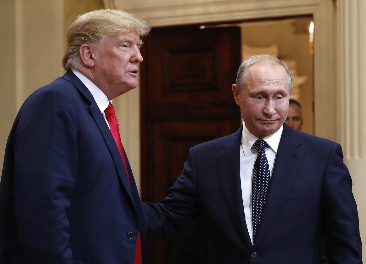 U.S. President Donald Trump, left, and Russian President Vladimir Putin leave a press conference after their meeting at the Presidential Palace in Helsinki, Finland, Monday, July 16, 2018. (AP Photo/Pablo Martinez Monsivais)