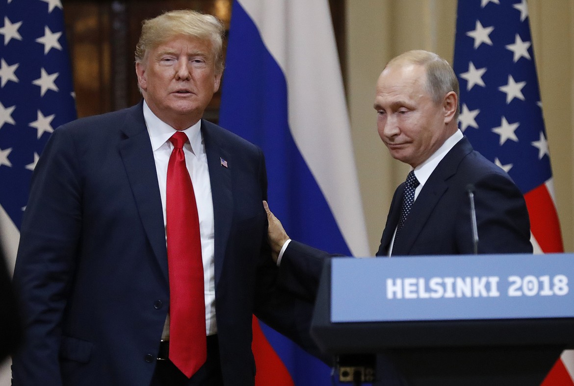 U.S. President Donald Trump, left, and Russian President Vladimir Putin leave after a press conference after their meeting at the Presidential Palace in Helsinki, Finland, Monday, July 16, 2018. (AP Photo/Alexander Zemlianichenko)