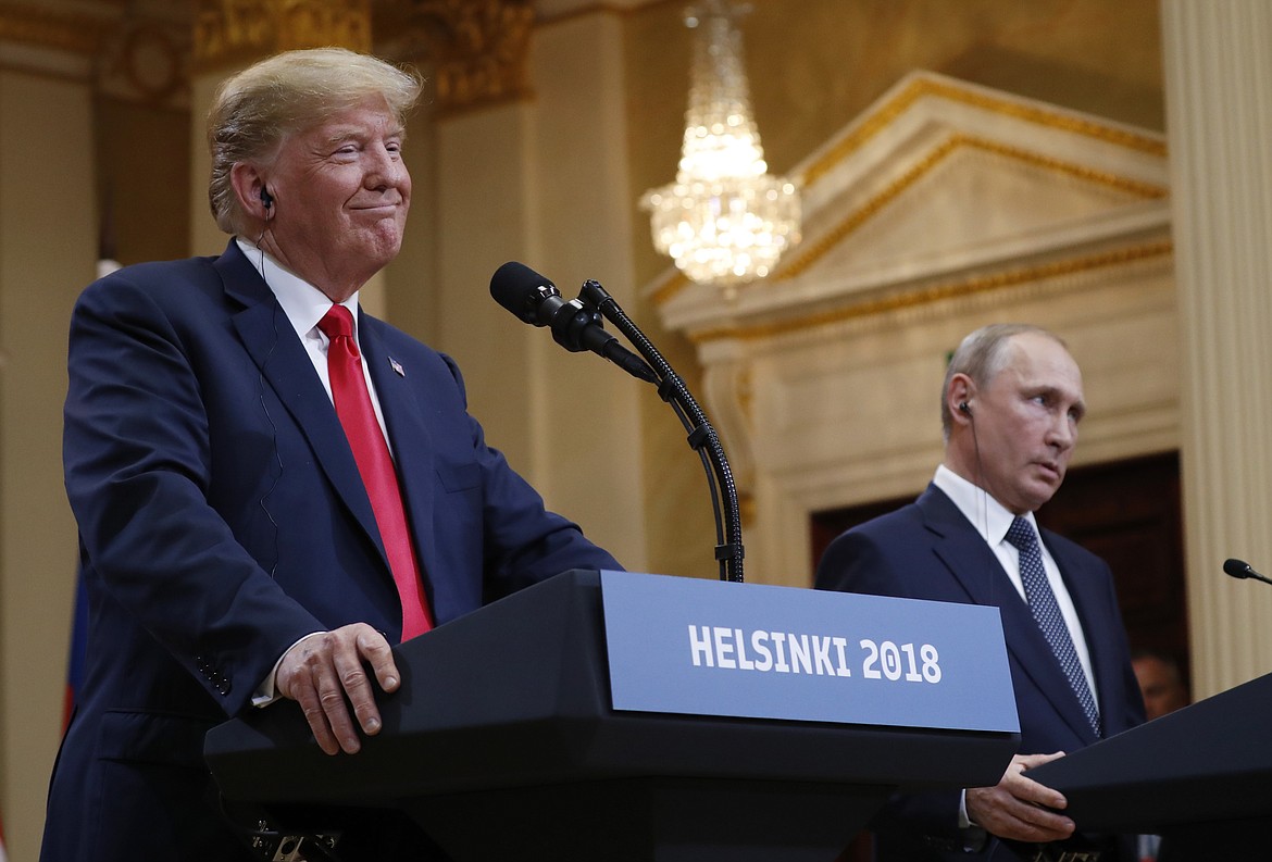 U.S. President Donald Trump, left, smiles beside Russian President Vladimir Putin during a press conference after their meeting at the Presidential Palace in Helsinki, Finland, Monday, July 16, 2018. (AP Photo/Pablo Martinez Monsivais)