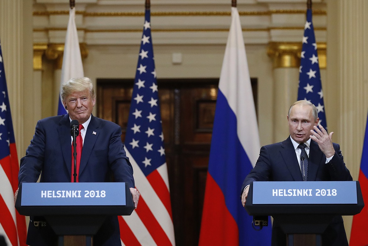 U.S. President Donald Trump, left, listens to Russian President Vladimir Putin during a press conference after their meeting at the Presidential Palace in Helsinki, Finland, Monday, July 16, 2018. (AP Photo/Alexander Zemlianichenko)