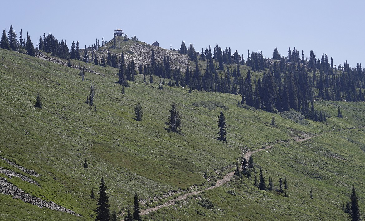 In this Wednesday, July 18, 2018, photo, the Coolwater Fire Lookout, upper left, sits high on a peak in the Nez Perce-Clearwater National Forests near Lowell, Idaho. The lookout has been staffed each summer for more than 100 years. Other towers across the U.S. West may seem like quaint reminders of an era before satellites, smartphones and jet-propelled air tankers, but the structures and the people who staff them play a crucial role in the nation's front-line efforts to stop wildfires. (AP Photo/Ted S. Warren)