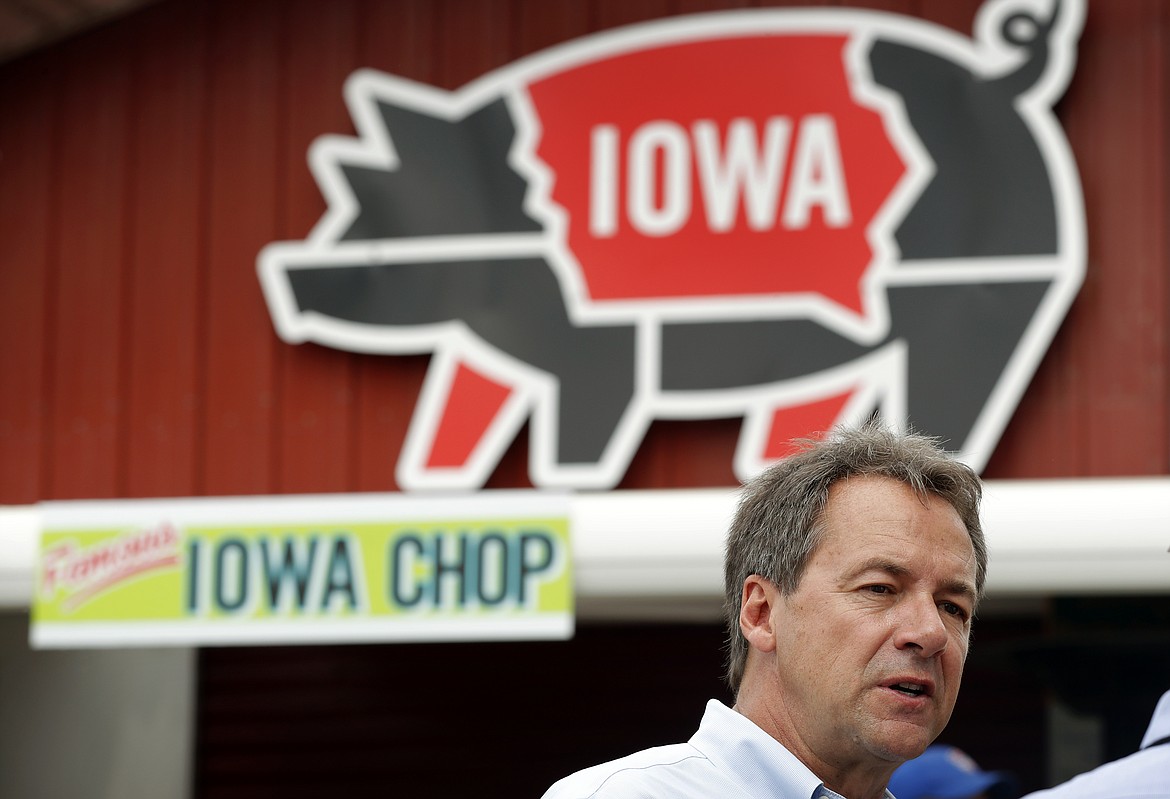 Montana Gov. Steve Bullock waits in line at the Iowa Pork Producers tent during a visit to the Iowa State Fair, Thursday, Aug. 16, 2018, in Des Moines, Iowa. (AP Photo/Charlie Neibergall)