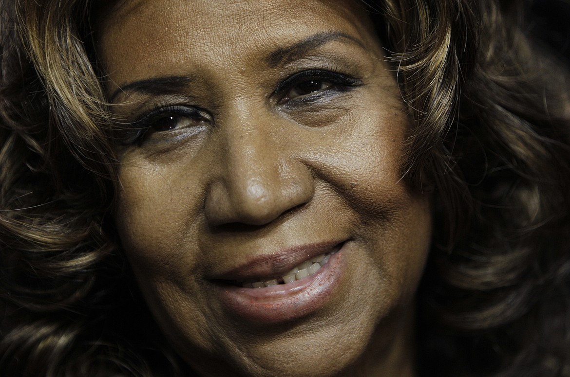 FILE - In this Feb. 11, 2011 file photo, Aretha Franklin smiles after the Detroit Pistons-Miami Heat NBA basketball game in Auburn Hills, Mich.   Franklin died Thursday, Aug. 16, 2018 at her home in Detroit.  She was 76. (AP Photo/Paul Sancya, File)