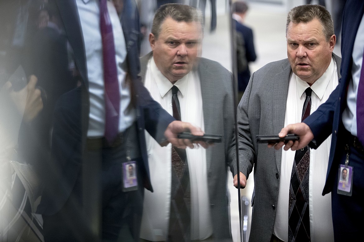 Sen. Jon Tester, D-Mont., listens to a question from a reporter as he arrives at the Capitol for policy luncheons, Tuesday, Sept. 25, 2018, in Washington. (AP Photo/Andrew Harnik)