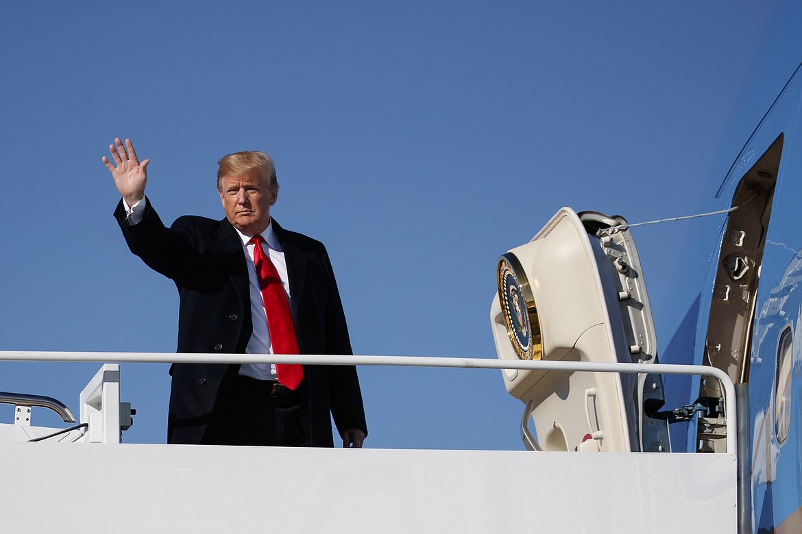 President Donald Trump waves as he boards Air Force One, Thursday, Oct. 18, 2018, in Andrews Air Force Base, Md., en route to speak at a campaign rally in Neptune Aviation Services, Missoula, Mont. (AP Photo/Carolyn Kaster)