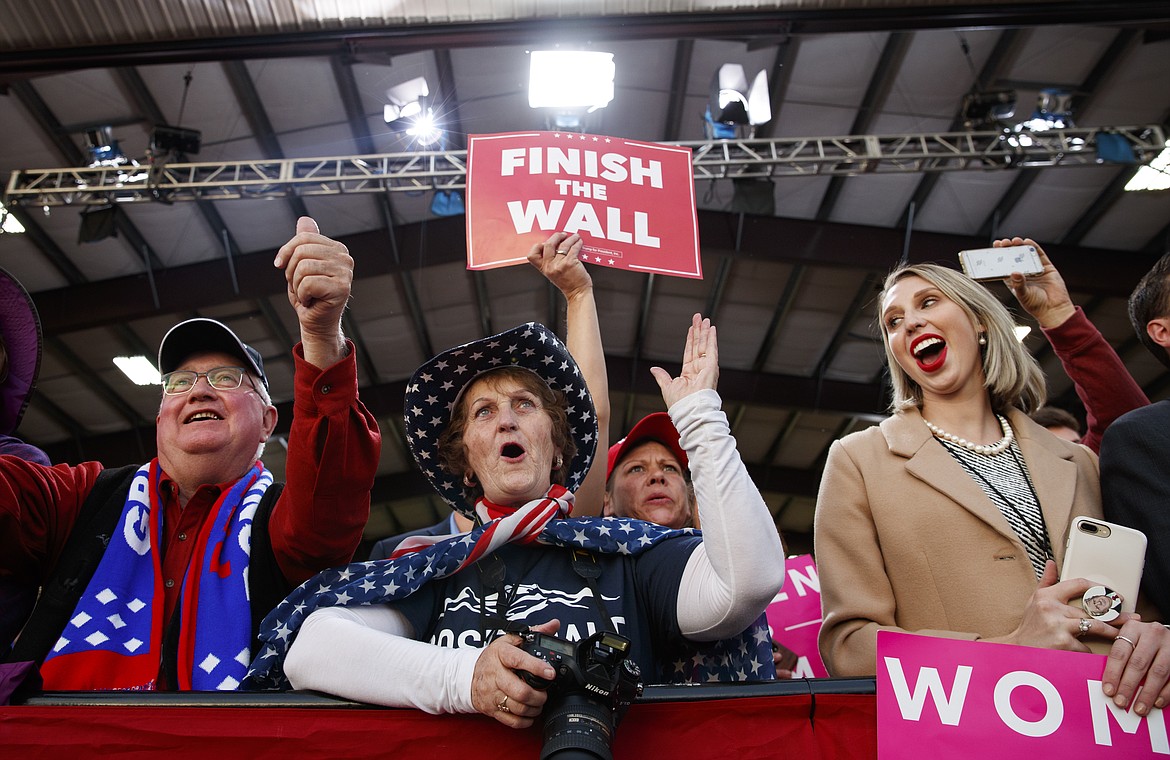 People in the audience cheer as President Donald Trump speaks at a campaign rally at Minuteman Aviation Hangar, Thursday in Missoula. (AP Photo/Carolyn Kaster)