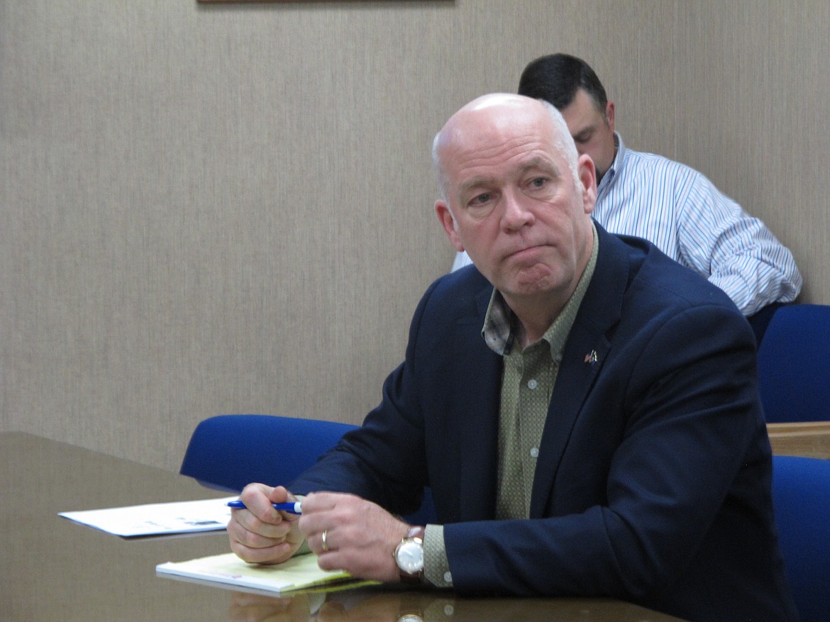 In this Tuesday, Oct. 9, 2018 photo Rep. Greg Gianforte listens during a meeting with leaders from the Montana Department of Justice and Montana Highway Patrol in Helena, Mont.. Gianforte is running against Democratic challenger Kathleen Williams to keep the congressional seat he won last year in a special election. (AP Photo/Matt Volz)