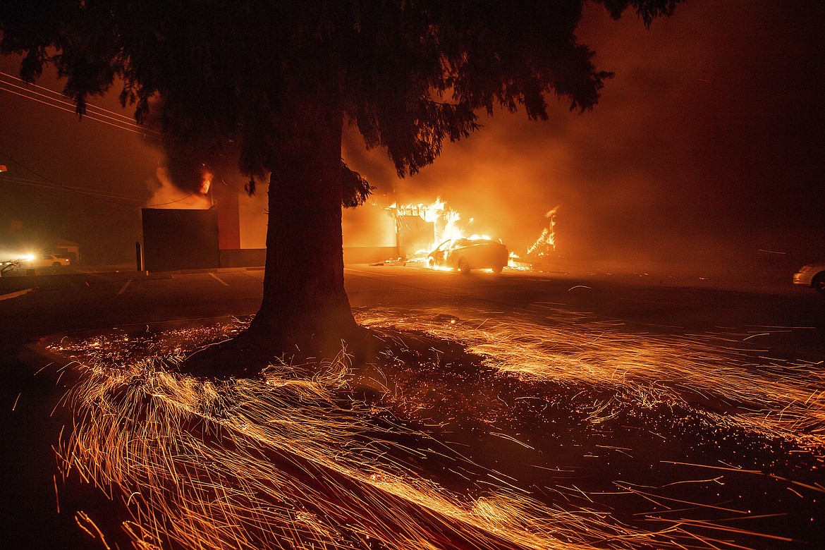 Flames consume a Kentucky Fried Chicken as the Camp Fire tears through Paradise, Calif., on Thursday, Nov. 8, 2018. Tens of thousands of people fled a fast-moving wildfire Thursday in Northern California, some clutching babies and pets as they abandoned vehicles and struck out on foot ahead of the flames that forced the evacuation of an entire town and destroyed hundreds of structures.  (AP Photo/Noah Berger)