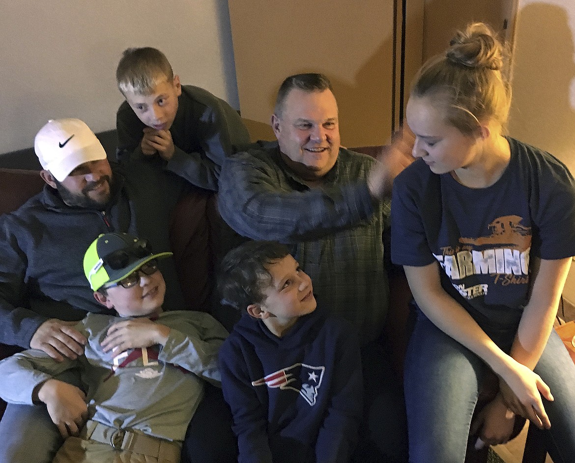 Montana Democratic Sen. Jon Tester waits with family for election results in his hotel room in Great Falls, Mont., Tuesday, Nov 6, 2018. From right to left are Kilikina Schultz, 14, Jon Tester; Tucker Schultz, 8; Brayden Schultz, 11; Dallin Wall, 10, and son-in-law, James Schultz. (AP Photo/Peter Banda)