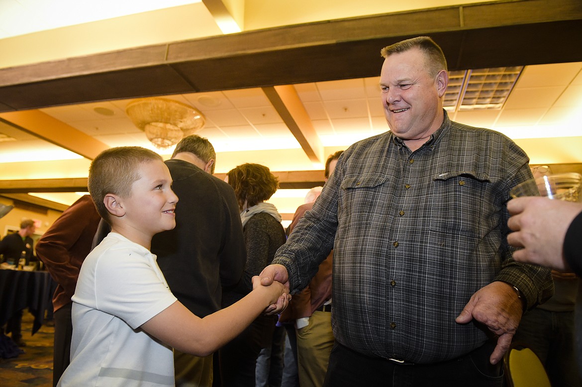 Montana Senator Jon Tester shakes hands with Jack Pinski Tuesday, Nov. 6, 2018, at his election party in Great Falls, Mont.  (Thom Bridge/Independent Record via AP)