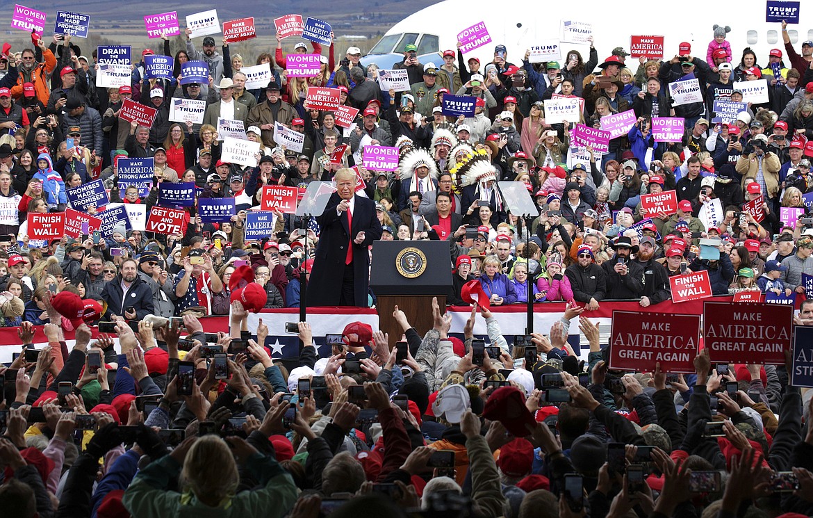 President Donald Trump reacts to the crowd during a campaign rally at Bozeman Yellowstone International Airport, Saturday, Nov. 3, 2018, in Belgrade, Mont. (AP Photo/Janie Osborne)