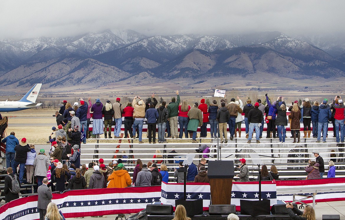 Supporters waves as Air Force One with President Donald Trump aboard, departs after a campaign rally at Bozeman Yellowstone International Airport, Saturday, Nov. 3, 2018, in Belgrade, Mont. (AP Photo/Janie Osborne)