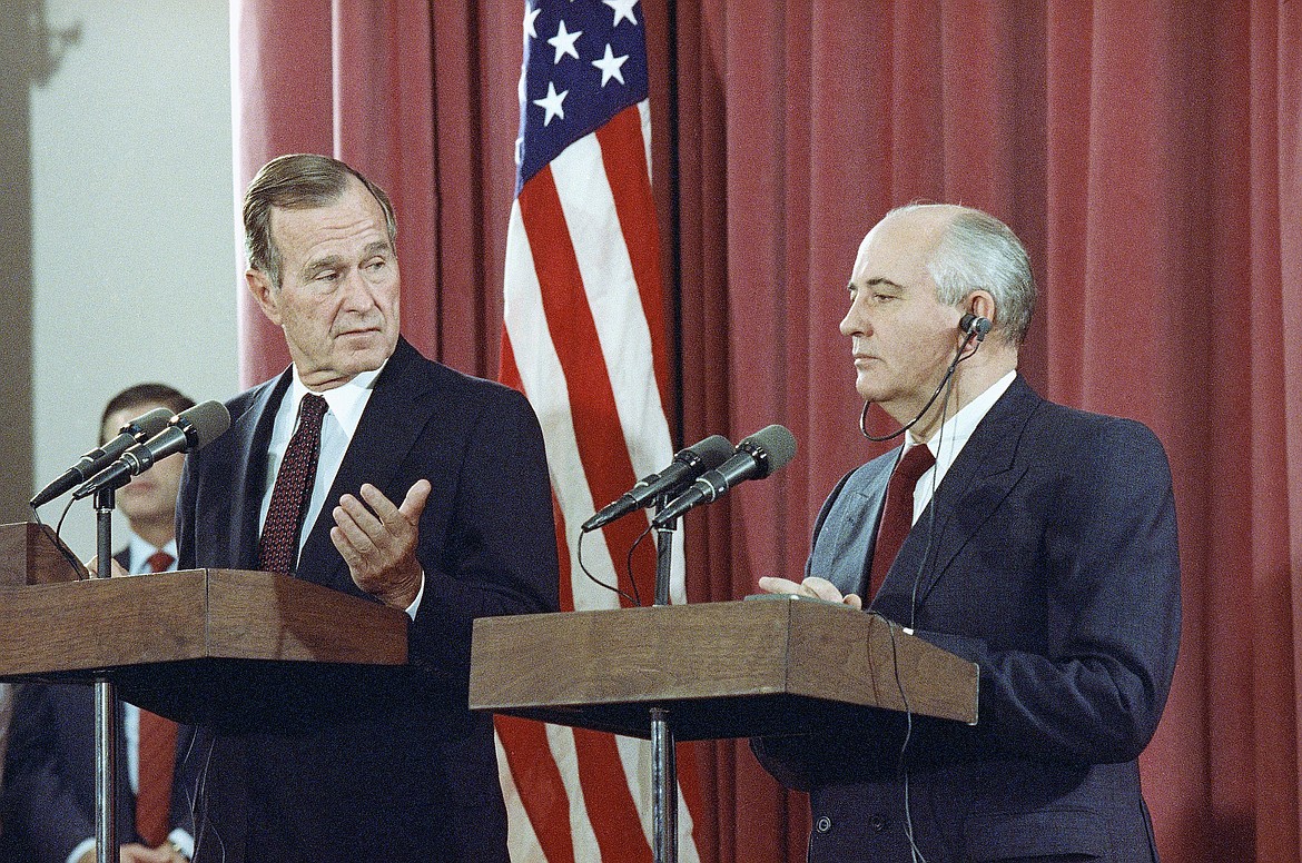 FILE - In this Oct. 29, 1991, file photo, President George H.W. Bush gestures during a joint news conference with Soviet President Mikhail Gorbachev,  at the Soviet Embassy in Madrid. Bush died at the age of 94 on Friday, Nov. 30, 2018, about eight months after the death of his wife, Barbara Bush. (AP Photo/Jerome Delay, File)