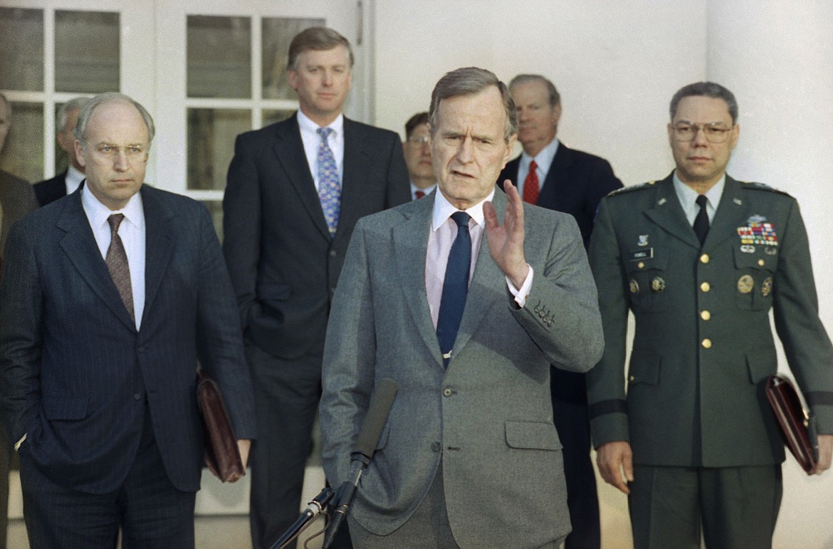 FILE - In this Feb. 11, 1991, file photo, President George H.W. Bush talks to reporters in the Rose Garden of the White House after meeting with top military advisors to discuss the Persian Gulf War. From left are, Defense Secretary Dick Cheney, Vice President Dan Quayle, White House Chief of Staff John Sununu, the president, Secretary of State James A. Baker III, and Joint Chiefs Chairman Gen. Colin Powell. Bush died at the age of 94 on Friday, Nov. 30, 2018, about eight months after the death of his wife, Barbara Bush. (AP Photo/Ron Edmonds, File)