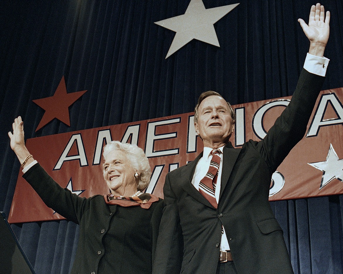 FILE - In this Nov. 8, 1988 file photo, President-elect George H.W. Bush and his wife Barbara wave to supporters in Houston, Texas after winning the presidential election. Bush has died at age 94. Family spokesman Jim McGrath says Bush died shortly after 10 p.m. Friday, Nov. 30, 2018, about eight months after the death of his wife, Barbara Bush. (AP Photo/Scott Applewhite, File)