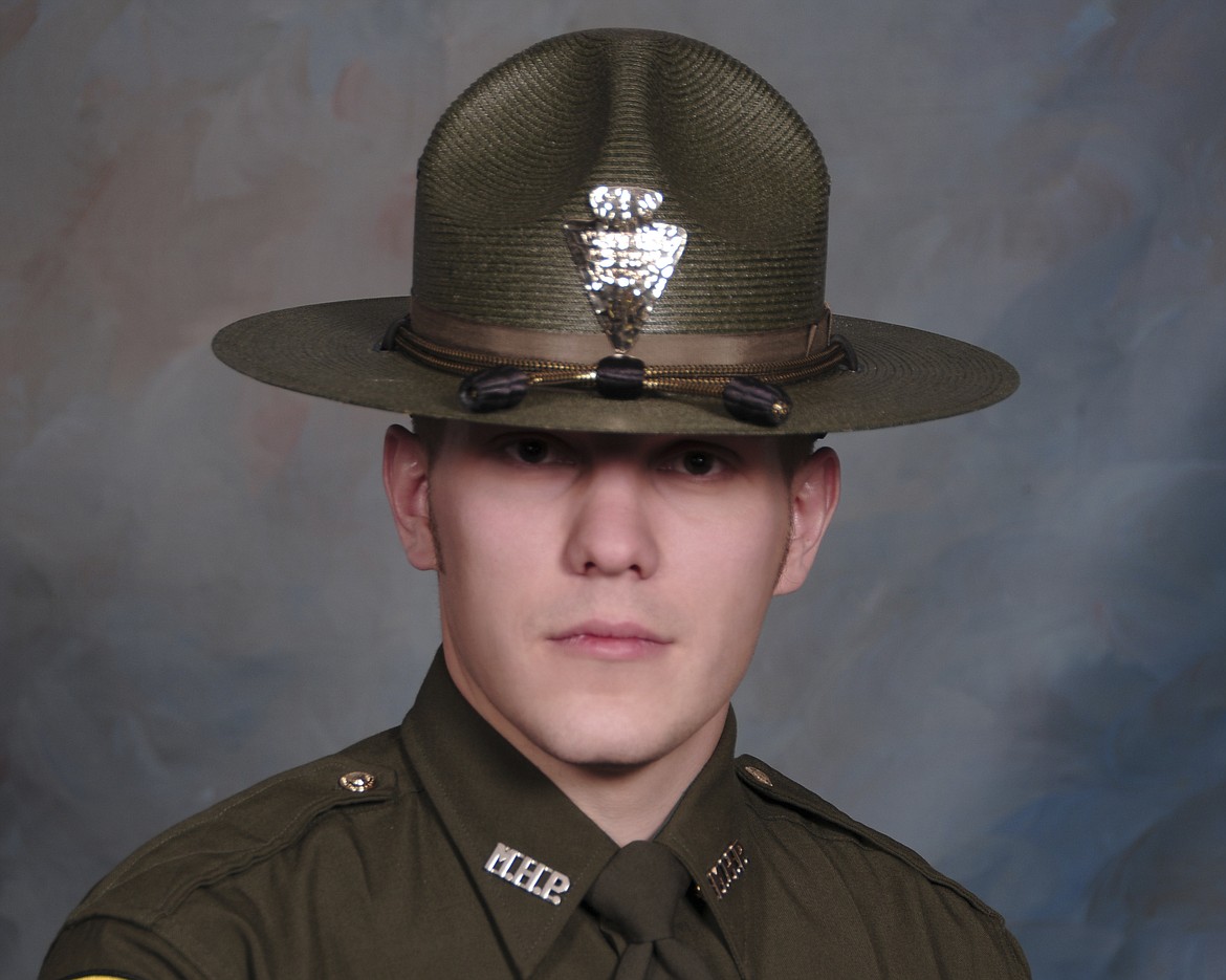 This undated booking photo provided by the Montana Highway Patrol shows Montana Highway Patrol Trooper Wade Palmer. Authorities say Palmer is in critical condition after being shot while investigating an earlier shooting in Missoula. Highway Patrol officials said in a statement Friday, March 15, 2019, another trooper found the wounded 35-year-old Palmer in his patrol car outside a bar in Evaro, Mont. early Friday. (Montana Highway Patrol via AP)