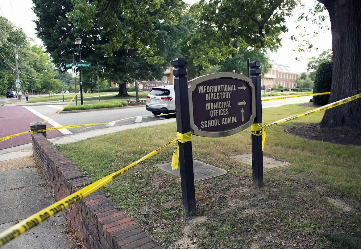 Police work the scene where eleven people were killed during a mass shooting at the Virginia Beach city public works building, Friday, May 31, 2019 in Virginia Beach, Va. A longtime, disgruntled city employee opened fire at a municipal building in Virginia Beach on Friday, killing 11 people before police fatally shot him, authorities said.  Six other people were wounded in the shooting, including a police officer whose bulletproof vest saved his life, said Virginia Beach Police Chief James Cervera. (L. Todd Spencer/The Virginian-Pilot via AP)
