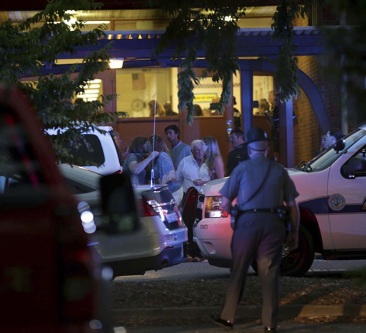 Family members gather outside the Princess Anne Middle School in Virginia Beach, Va, on Friday, May 31, 2019. A longtime city employee opened fire at a municipal building in Virginia Beach on Friday, killing 11 people before police shot and killed him, authorities said. Six other people were wounded in the shooting, including a police officer whose bulletproof vest saved his life, said Virginia Beach Police Chief James Cervera. (AP Photo/Vicki Cronis-Nohe)