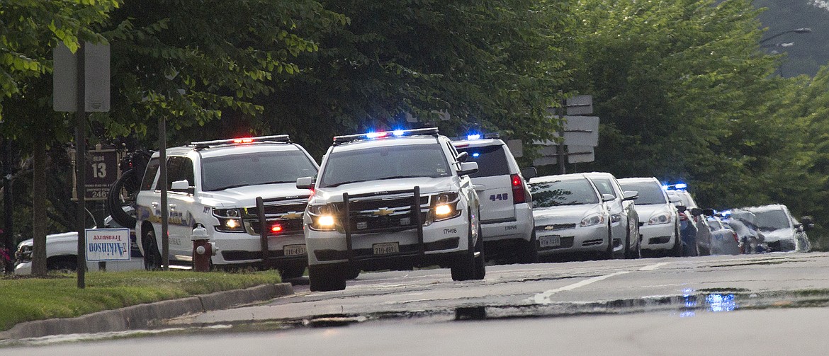 Police work the scene of a mass shooting at the Virginia Beach city public works building Friday, May 31, 2019 in Virginia Beach, Va. A longtime city employee opened fire at a municipal building in Virginia Beach on Friday, killing 11 people before police shot and killed him, authorities said. Six other people were wounded in the shooting, including a police officer whose bulletproof vest saved his life, said Virginia Beach Police Chief James Cervera. (L. Todd Spencer/The Virginian-Pilot via AP)