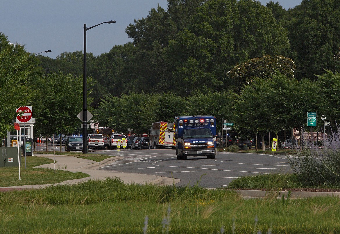 Emergency vehicles respond near the intersection of Princess Anne Road and Nimmo Parkway following a shooting at the Virginia Beach Municipal Center on Friday, May 31, 2019, in Virginia Beach, Va. At least one shooter wounded multiple people at a municipal center in Virginia Beach on Friday, according to police, who said a suspect has been taken into custody. (Kaitlin McKeown/The Virginian-Pilot via AP)