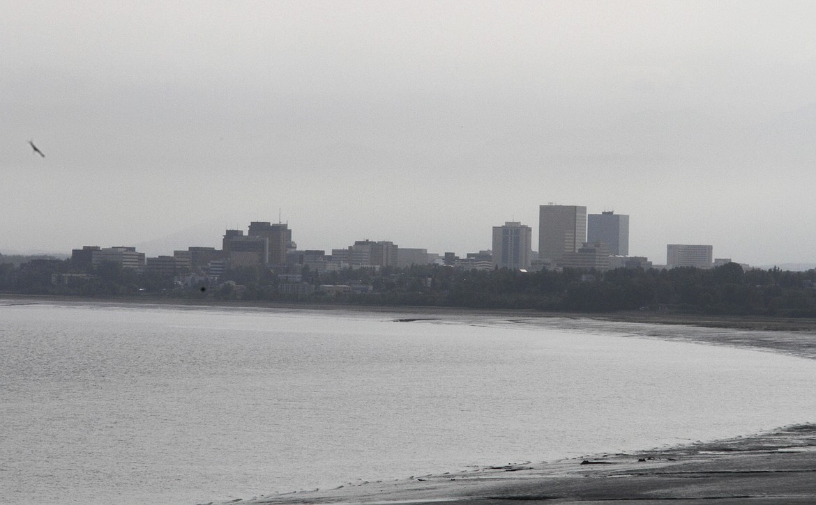 A smoky haze from a wildfire on Alaska's Kenai Peninsula obscures the Chugach Mountains that normally tower over downtown Anchorage, Alaska, and Cook Inlet, some 60 miles away (100 km) from the fire, on Tuesday, June 25, 2019. (AP Photo/Mark Thiessen)