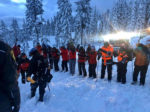 Rescue crews use probes to search the Wardner Peak area at Silver Mountain, Idaho. Two skiers were killed in an avalanche at the ski resort on Tuesday and another is still missing (Courtesy photo)