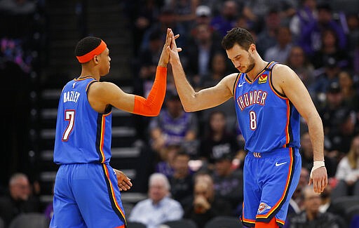 Oklahoma City Thunder' Darius Bazley, left, and Danilo Gallinari, right, high-five during the second half of the NBA basketball game against the Sacramento Kings in Sacramento, Calif., Wednesday, Jan. 29, 2020. The Thunder won 120-100. (AP Photo/Rich Pedroncelli)