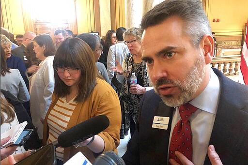 Indiana Hospital Association President Brian Tabor speaks with reporters Monday, March 2, 2020, at the Statehouse in Indianapolis. Tabor and other hospital officials argue that a legislative proposal limiting how much hospitals could charge for procedures done at non-hospital facilities could lead to widespread medical service cuts. (AP Photo/Tom Davies)