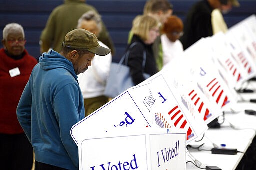 A voter fills out his ballot at a primary polling place, Saturday, Feb. 29, 2020, in North Charleston, S.C. (AP Photo/Patrick Semansky)