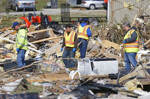 Workers search for victims among the rubble in an area where several people were killed by storms Tuesday, March 3, 2020, near Cookeville, Tenn. Tornadoes ripped across Tennessee early Tuesday, shredding more than 140 buildings and burying people in piles of rubble and wrecked basements. At least 22 people were killed. (AP Photo/Mark Humphrey)