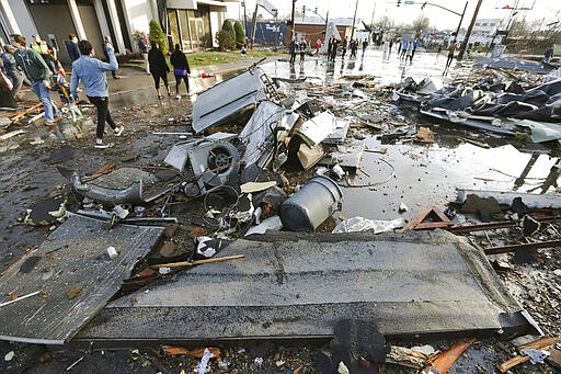 Debris covers a street after overnight storms Tuesday, March 3, 2020, in Nashville, Tenn. Tornadoes ripped across Tennessee early Tuesday, shredding buildings and killing multiple people.  (AP Photo/Mark Humphrey)