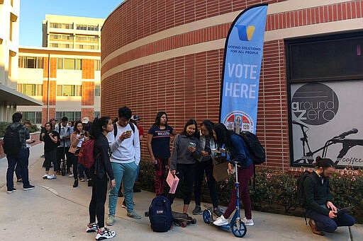 Voters wait on line at a polling station at the University of Southern California on Tuesday, March 3, 2020. Some California voters are waiting in long lines because of technical glitches connecting to the statewide voter database or too many users trying to cast ballots at once. The secretary of state's office said election workers in 15 counties could not connect to the statewide voter registration database on Super Tuesday but that the issues have been resolved. (AP Photo/Stefanie Dazio)