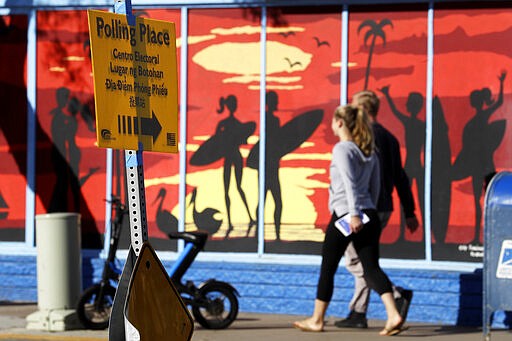 People make their way to a polling place to vote during primary elections Tuesday, March 3, 2020, in San Diego. California officials bracing for long lines are urging patience as voters cast ballots on &quot;Super Tuesday&quot; in what could be record turnout for a presidential primary election. (AP Photo/Gregory Bull)