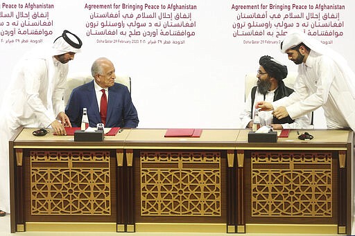 U.S. peace envoy Zalmay Khalilzad, left, and Mullah Abdul Ghani Baradar, the Taliban group's top political leader sign a peace agreement between Taliban and U.S. officials in Doha, Qatar, Saturday, Feb. 29, 2020. The United States is poised to sign a peace agreement with Taliban militants on Saturday aimed at bringing an end to 18 years of bloodshed in Afghanistan and allowing U.S. troops to return home from America's longest war. (AP Photo/Hussein Sayed)