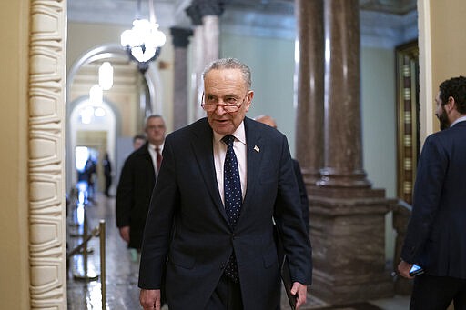Senate Minority Leader Chuck Schumer, D-N.Y., arrives to speaks to reporters after the Senate voted to approve a bipartisan measure limiting President Donald Trump's authority to launch military operations against Iran, at the Capitol in Washington, Thursday, Feb. 13, 2020. (AP Photo/J. Scott Applewhite)