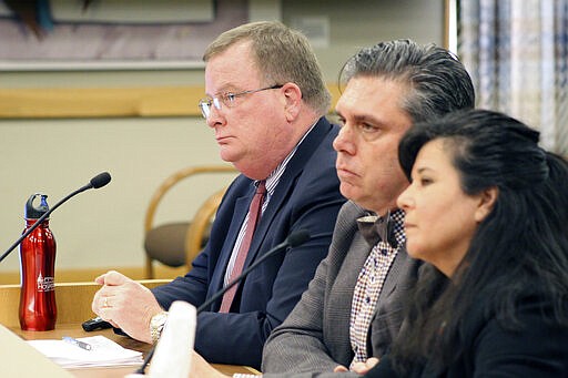 Three officials of the Oregon Health Authority testified on Friday, Feb. 28, 2020, before a committee of the Oregon Legislature in Salem, on preparations for a possible outbreak of coronavirus in Oregon. Appearing before the House Committee on Health Care were, from left, OHA Director Patrick Allen, Dean Sidelinger, state health officer and state epidemiologist, and Akiko Saito, section manager of health security, preparedness and response. (AP Photo/Andrew Selsky)