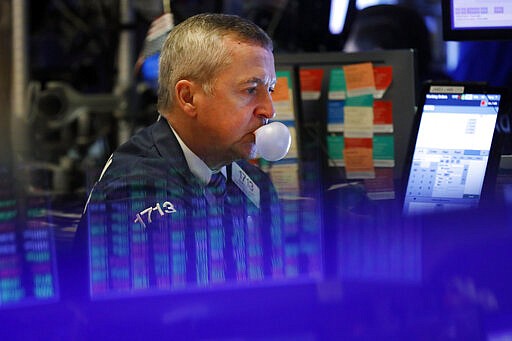 Trader James lamb works on the floor of the New York Stock Exchange, Tuesday, March 3, 2020. Stocks are falling sharply on Wall Street, erasing a brief early rally, after an emergency interest-rate cut by the Federal Reserve failed to wipe out fears that a fast-spreading virus outbreak could lead to a recession. (AP Photo/Richard Drew)