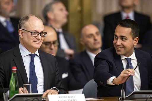 Italian Economy Minister Roberto Gualtieri, left, and Foreign Minister Luigi Di Maio attend the &quot;2020 Extraordinary Plan for Promoting Made In Italy&quot;, at the Farnesina foreign ministry headquarters in Rome, Tuesday, March 3, 3030. The Italian government has presented a plan to help Italian producers struggling with the economic effects of the coronavirus outbreak. (Roberto Monaldo/LaPresse via AP)