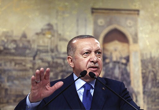 Turkey's President Recep Tayyip Erdogan speaks to his ruling party's lawmakers, in Istanbul, Saturday, Feb. 29, 2020. Erdogan said Saturday that his country's borders with Europe were open, as thousands of refugees gathered at the frontier with Greece.(Presidential Press Service via AP, Pool)