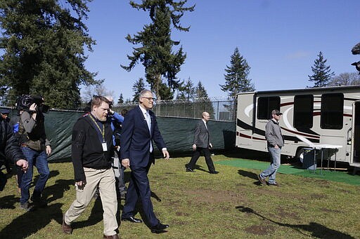 Washington Gov. Jay Inslee, right, is joined by Nathan Weed, incident commander for the coronavirus response team at Department of Health, as they arrive at a potential coronavirus isolation and quarantine site, Wednesday, March 4, 2020, in Centralia, Wash. The state has now reported 39 COVID-19 cases, all in the greater Seattle area, including 10 deaths. (AP Photo/Rachel La Corte)