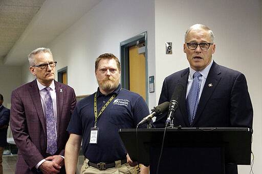 Washington Gov. Jay Inslee speaks to the press at about the latest updates on coronavirus in the state, while joined by Secretary of Health John Wiesman and Nathan Weed, incident commander for the coronavirus response team, center, Wednesday, March 4, 2020, in Tumwater, Wash. The state has now reported 39 COVID-19 cases, all in the greater Seattle area, including 10 deaths. (AP Photo/Rachel La Corte)