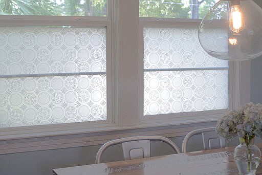 This photo shows StickPretty Gothica window film which shields street views from this family kitchen table while still allowing tree-filled sight lines. Renters have traditionally been limited in how boldly they can decorate and still get their security deposit back. But new products are making renters' decorating dreams more doable. (Christy Flannigan/StickPretty via AP)