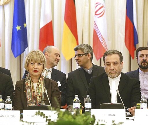 The European Union's political director Helga Schmid and Iran's deputy Foreign Minister Abbas Araghchi, from left, wait for a bilateral meeting as part of the closed-door nuclear talks with Iran in Vienna, Austria, Wednesday, Feb. 26, 2020. (AP Photo/Roland Zak)