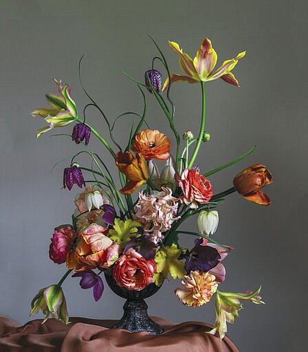 This photo shows a floral display featured in the book "Cultivated: The Elements of Floral Style" by Christin Geall. In lighting fixtures, wallpapers, bedding and wall art, floral design is having a big year in 2020. There's also a renewed interest in flower arranging and floral-inspired table settings. (Christin Geall/Princeton Architectural Press via AP)