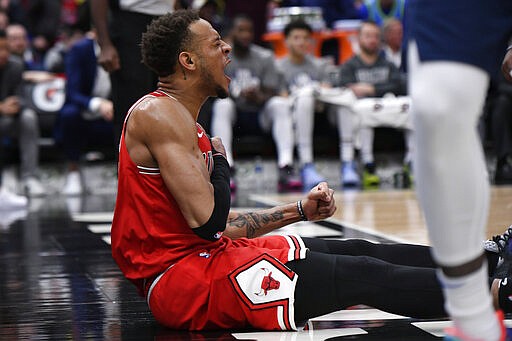 Chicago Bulls' Daniel Gafford (12) celebrates after being fouled while dunking over Dallas Mavericks' Dorian Finney-Smith during the second half of an NBA basketball game Monday, March 2, 2020, in Chicago. (AP Photo/Paul Beaty)