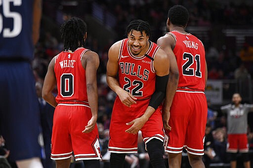 Chicago Bulls' Otto Porter Jr. (22) celebrates with teammates Coby White (0) and Thaddeus Young (21) after being fouled while making a basket during the second half of an NBA basketball game against the Dallas Mavericks, Monday, March 2, 2020, in Chicago. (AP Photo/Paul Beaty)